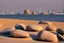 Placeholder: Sunny day, people, rocks, sand, distant modern city