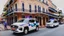 Placeholder: A police Tesla Cybertruck is chasing a Tesla 'Model S Plaid' at top speed, across the 'French Quarter' in New Orleans, Louisiana. CINEMATIC. WIDE ANGLE LENS.
