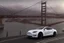 Placeholder: A Tesla 'Model Y' is parked, on the 'Golden Gate' bridge. (CINEMATIC, WIDE ANGLE LENS, PHOTO REAL)