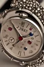 Placeholder: Silver wristwatch studded with precious stones containing the word jiks