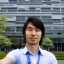 Placeholder: A long haired, Japanese Male software engineer from MIT taking a selfie in front of Building 92 at Microsoft in Redmond, Washington