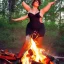 Placeholder: a busty voluptuous female folk hero dancing by a bonfire