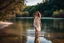 Placeholder: beautiful girl in pretty dress walking in water toward camera in trees next to wavy river with clear water and nice sands in floor.camera capture from her full body front