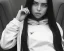 Placeholder: Billie Eilish, sitting on a chair, Black Short Dress, high detail, realistic, 8k