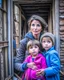 Placeholder: a poor worried mother with children taking shelter under damaged building in war torn city of Ukraine