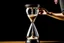 Placeholder: A picture of a person holding a hourglass symbolizes the importance of time management and making the most of it.