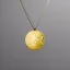 Placeholder: necklace with a simple, elegant design featuring a single, shimmering polyester in moon pendant