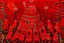 Placeholder: A dark red festival with bells designed in Kuna molas painted by Claude Monet