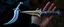 Placeholder: "A fantasy dagger inspired by a squid's tentacles, designed like a talon. The blade is curved and organic, shimmering with iridescent colors like deep-sea creatures. Its handle resembles a coiled squid arm, with tiny suckers and subtle bioluminescent patterns glowing in blues and purples. The overall design looks both ancient and alien, like a relic from an underwater civilization. The dagger is displayed on dark velvet or held by a gloved hand."