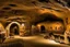 Placeholder: A brownish bronze underground mining village designed in Lascaux cave paintings painted by Diego Rivera