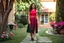 Placeholder: very beautiful lady with beautiful midi dark black-red skirt and top with curvy hair sports shoes standing in a nice villa yard with trees flowers ,16 by 9