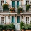 Placeholder: The facade of an old white house with a door, window and balcony decorated with flowers