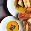 Placeholder: A beautiful picture of a Carrot pumpkin cream soup with garlic bread. The soup is full of flavor and the garlic bread is delicious.