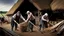 Placeholder: young and old people working in the field near medieval barns