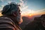 Placeholder: a large middle-aged man with grey hair views sunset from a cliff