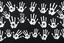 Placeholder: multiple white hand prints on a solid black background. some hand prints have streak marks as if they slid down the canvas