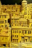 Placeholder: A yellow short city with battery shaped buildings designed in ancient Greek pottery painted by Vincent van Gogh