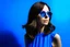 Placeholder: advertising photography, plain blue background, pop style photography, woman in blue dress, brunette, round sunglasses, real photography, 16K, shot with Leica camera, 35 mm lens, indirect lighting,