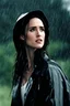 Placeholder: Beautiful 25 year-old Jennifer Connelly standing outside in a rain shower with no rain-coat, umbrella, or hat, with her head tilted up to the sky, her tongue sticking out and catching raindrops