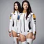 Placeholder: Ah, the twin women's leotard space suits are not just simple attire, but a fusion of style and functionality. These unique ensembles feature an abundance of zippers and badges, adding an extra layer of visual intrigue to their lunar expedition. The leotards, snug against their bodies, are adorned with various metallic zippers, strategically placed to accentuate their curves while allowing ease of movement. Each zip serves as a tantalizing invitation to explore what lies beneath, a playful tease