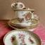 Placeholder: exquisite whimsical tea set in embroidery hoop, intricate, highly detailed, linen and wood backdrop