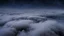 Placeholder: above looking down from space at the mist and clouds, surrounded by the mist at night starry sky. majority of the image is space