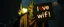 Placeholder: Glowing ghoul mutant guru from fallout 4 holds up sign saying "I love wifi!"