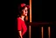 Placeholder: woman with a red baseball hat. leaning on a wooden balcony.night time. studio lightining.