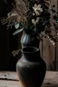 Placeholder: detail image of an old black rustic vase with flowers on a wooden table. modern farmhouse style with rustic feeling.