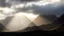 Placeholder: Mountainous landscape on Kerguelen, dramatic sunlight, chiaroscuro, beautiful composition, award-winning photograph