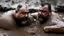 Placeholder: wide angle photography of two 55 years old sicilian burly chubby mud men fighting in the mud, long hair, beards, manly chest, bullneck , photorealistic , view from the ground