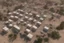 Placeholder: Can you please come up with a design concept for a refugee camp that houses displaces Palestinians that is Meaningful, resilient, self sufficient, safe and takes into consideration Palestinians culture and religious beliefs in the dessert using shipping containers