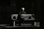 Placeholder: man sitting on a bench in the street