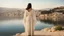 Placeholder: [the time of Jesus] close to the old town of Nazareth, a view on the Lake of Genesareth. a young woman in linen dress, she has her wooden rod she looks at the people down around the shore