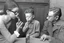 Placeholder: a photo of child-like Simone de Beauvoir and child-like Jean-Paul Sartre meeting child-like Che Guevara who is lighting a cigar for child-like Jean-Paul Sartre