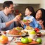 Placeholder: A man with his family at the dining table eating an extremely healthy meal of fresh Whole Foods