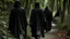 Placeholder: black robe hooded monks on the forest path