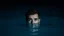 Placeholder: A Young Man Humorously Looking Straight With Only His Head And Beautiful Eyes Are Appearing From The Surface Of The Blue Water At Dark Night Showing Dramatic And Cinematic Ambiance.