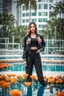 Placeholder: fullbody shot of young-beautiful-girl-with-a-perfect-face-with-make-up-wearing- sport pants and jacket standing in big Square with a round pool with clean water in center , modern city scape environment , flowers,