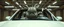 Placeholder: car driving happy 2d fluffy alien hippo bunny ogre man in the style of Escher and Giger and Fallout 4, pinhole cam, airbrush 3d rendering, on tv screen:A five-second cinematic single take in a clean industrial presentation hall.