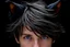 Placeholder: A man with messy black hair, black cat ears on his head, blue eyes.