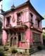 Placeholder: A rosy pink magical voodoo house in a district painted by Leonardo da Vinci