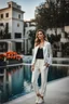 Placeholder: fullbody shot of young-beautiful-girl-with-a-perfect-face-with-make-up-wearing- sport pants and jacket standing in big Square with a pool clean water in center ,nice nature in modern city scape environment , flowers,