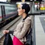 Placeholder: A beautiful slender transgender woman with short black hair waiting for a man at a train station in London