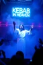 Placeholder: An "Kebab man" performing at dance club, his name is "Kebab man" and looks crazy, Jesus on stage, White and light blue Neon lights and smog, "KEBAB IN HEAVEN" SIGN ON WALL