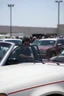 Placeholder: A very angry and bitter punk rocker tries to get in his car, while a other car is to close on a crowded parking lot
