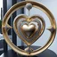 Placeholder: A magnificent golden and silver heart-shaped sign adorned with a stunning golden sphere encrusted with sparkling diamond clusters at its center, elegantly spinning in position.