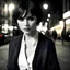 Placeholder: woman with short dark hair, in a fashionable cardigan, against the background of the street, {day|night}, stylish photo, in the style of Peter Lindbergh