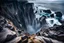 Placeholder: This mesmerizing ocean cliff scene captures the dramatic power and beauty of nature. Towering rugged cliffs stand majestically against the vast expanse of the ocean, where the water pours into a singular bottomless pit. The cliffs, with their sharp and jagged edges, create a stark contrast to the rough, flowing water, making the scene even more captivating. Sunlight pierces through the mist rising from the waterfalls, creating a magical, ethereal atmosphere