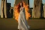 Placeholder: Full body shot of a tall slim red-headed young woman, dressed like a gipsy, standing in front of Stonehenge in a flaming circle